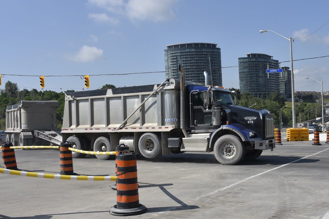 A dump truck moves through an intersection.